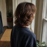 Person with long center-parted hair sweeping down beside the face