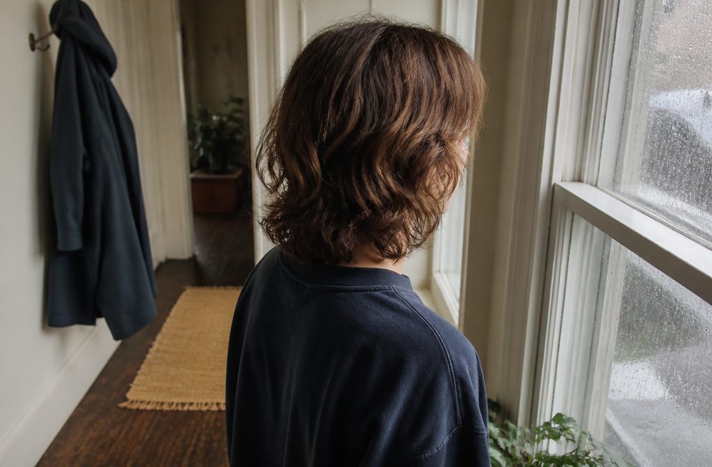 Person with long center-parted hair sweeping down beside the face