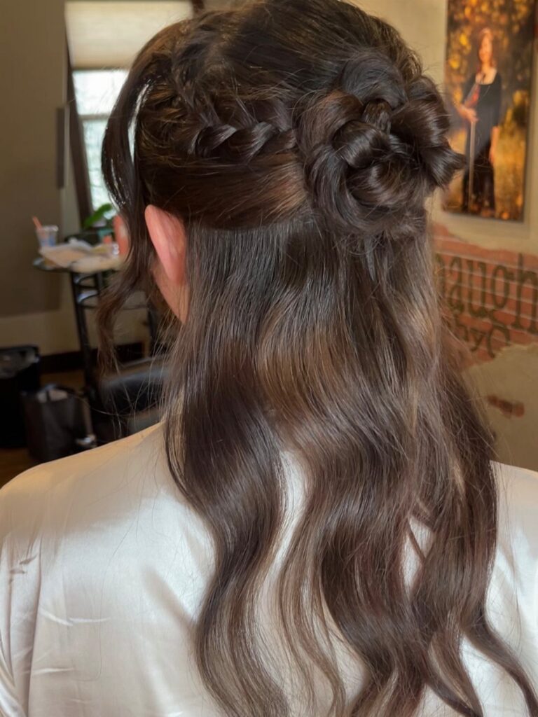 Braided half-up bun with tiny side braids and long loose waves