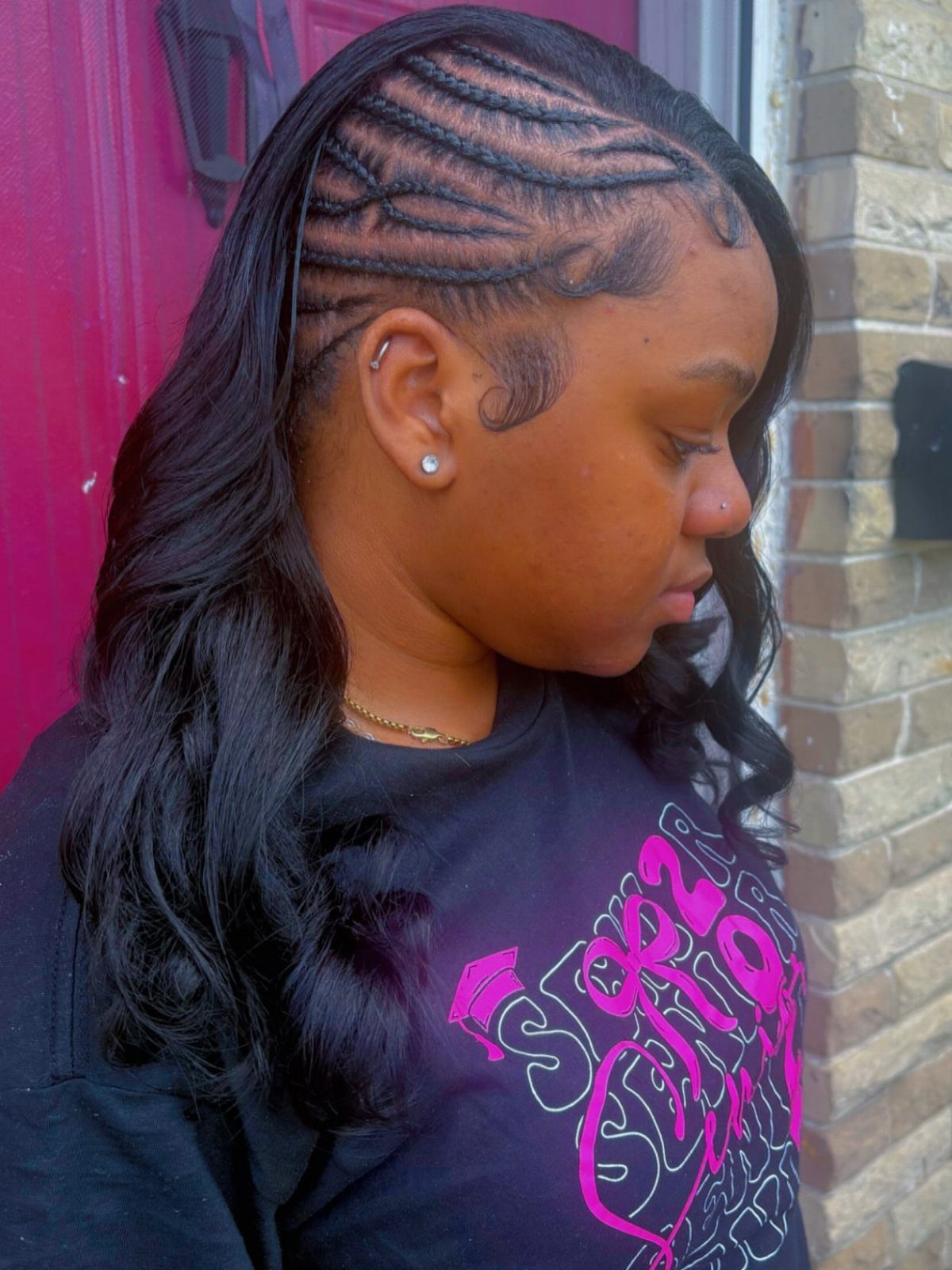 Woman showing long wavy hair with close side braids and a swooping hairline