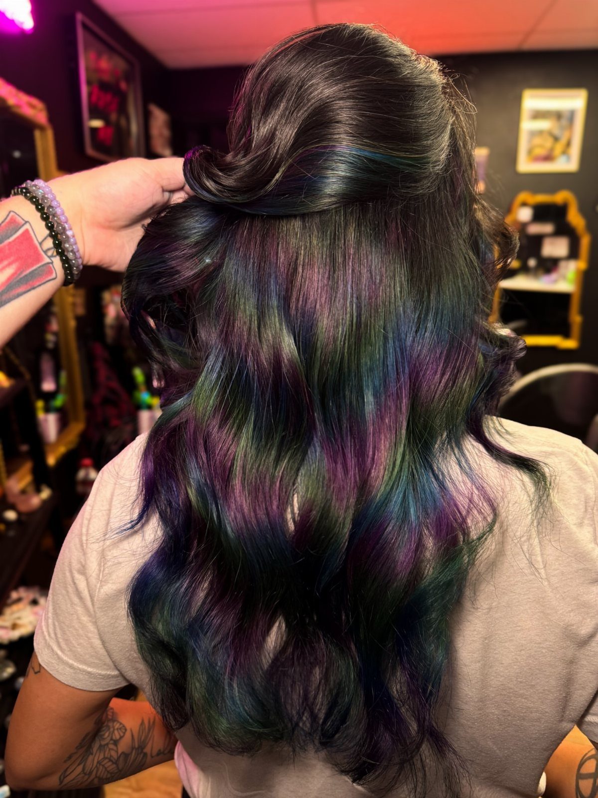Wavy dark oil slick hair shimmering with green, blue, and purple highlights