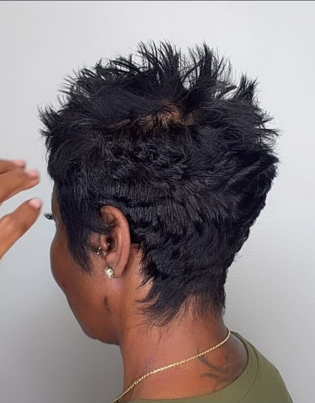 Spiky dark top rises above closely trimmed sides and nape